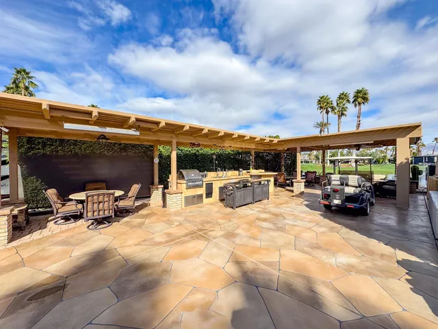 a view of a patio with a table chairs and a table