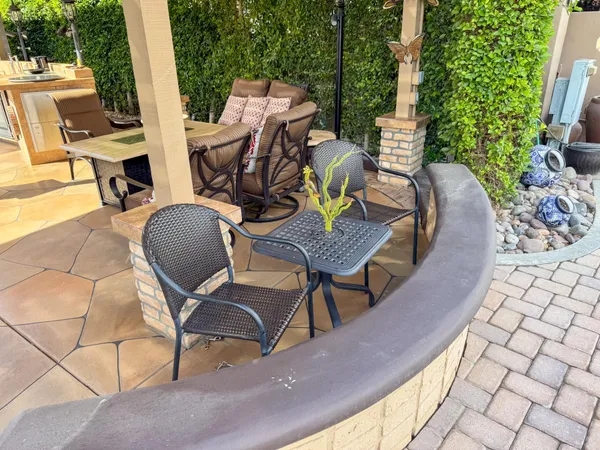 a view of a patio with table and chairs and potted plants