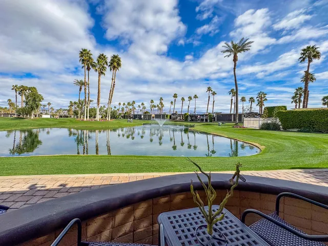 an outdoor sitting area with swimming pool and furniture