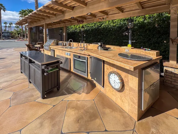 a view of a kitchen with a stove and a microwave oven on the terrace