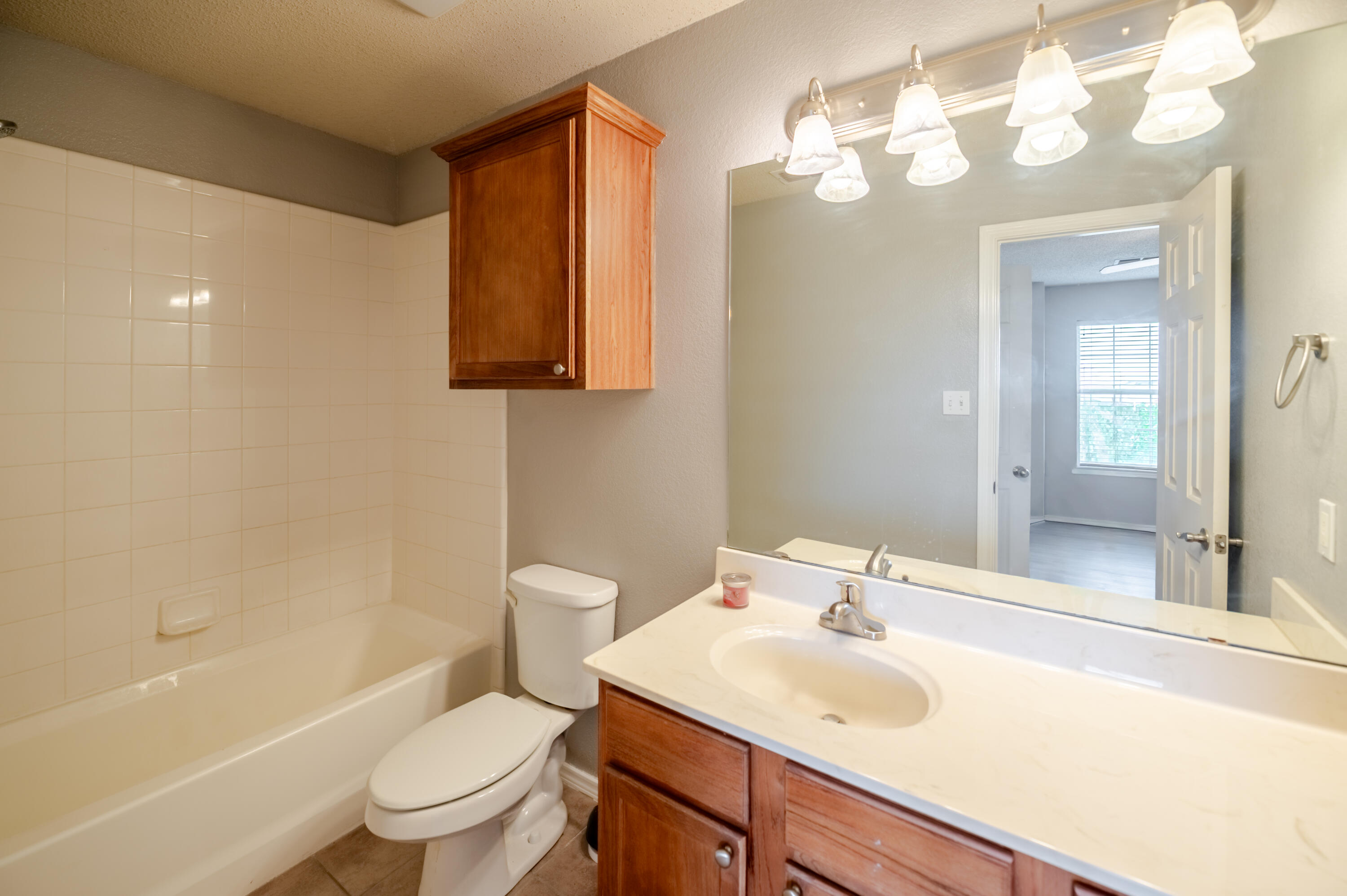 2111 Main Street, Unit 1 Lubbock, TX 79401 - Photo 15 of 36 a bathroom with a sink toilet vanity and shower