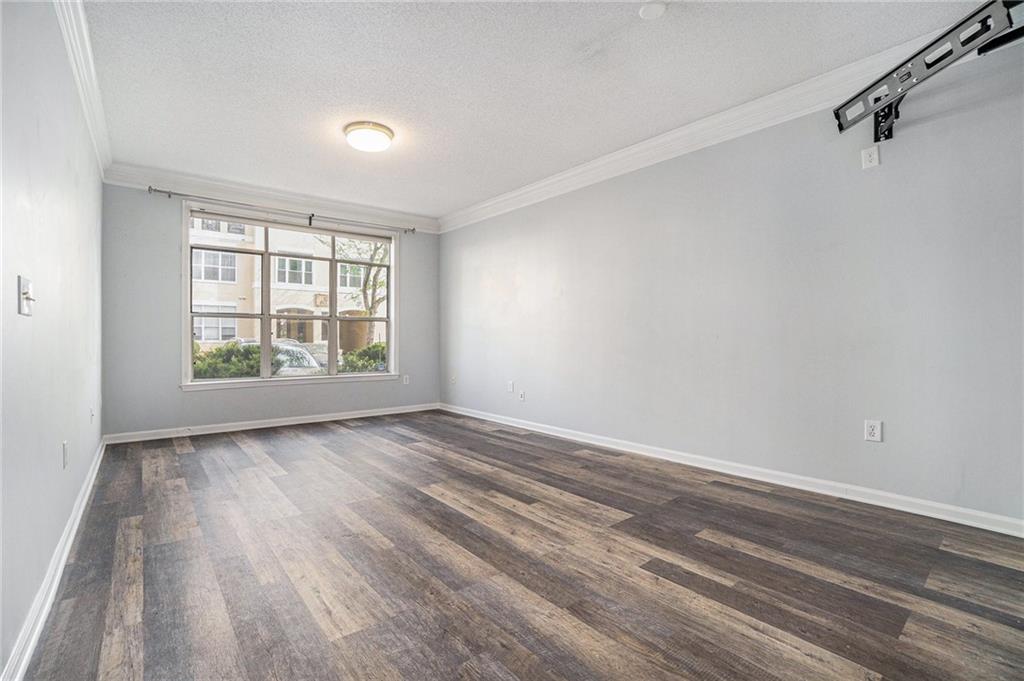 955 Juniper Street Northeast, Unit 3026 Atlanta, GA 30309 - Photo 12 of 32 wooden floor in an empty room with a window