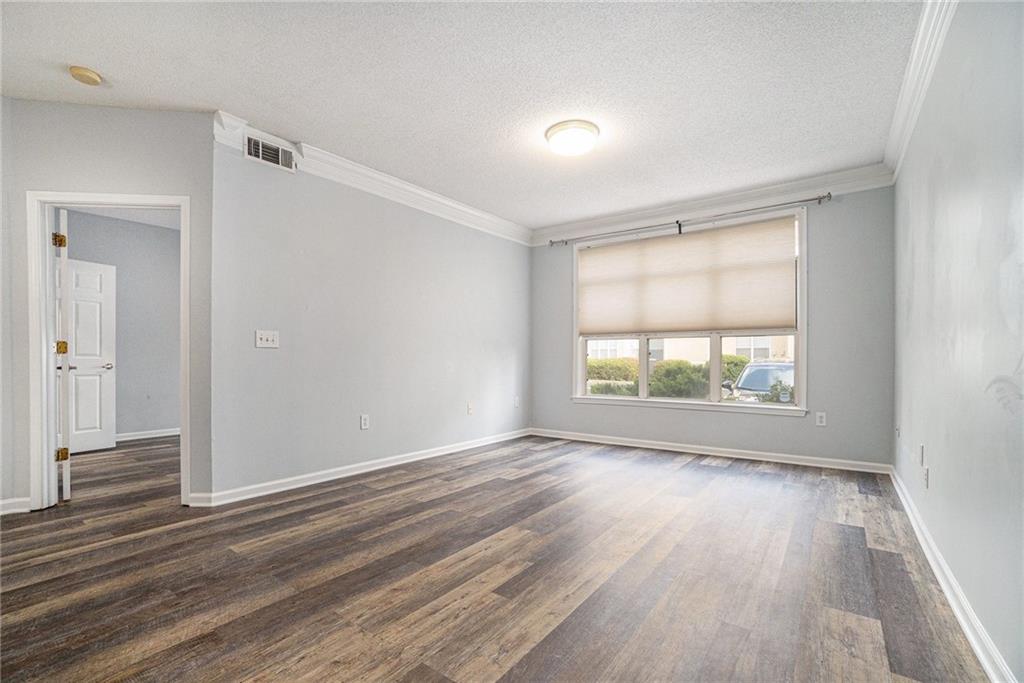 955 Juniper Street Northeast, Unit 3026 Atlanta, GA 30309 - Photo 15 of 32 an empty room with wooden floor and windows