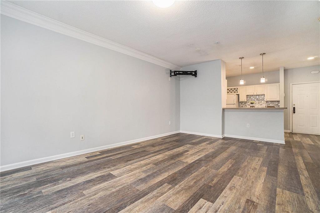 955 Juniper Street Northeast, Unit 3026 Atlanta, GA 30309 - Photo 16 of 32 a view of a kitchen with wooden floor and a sink