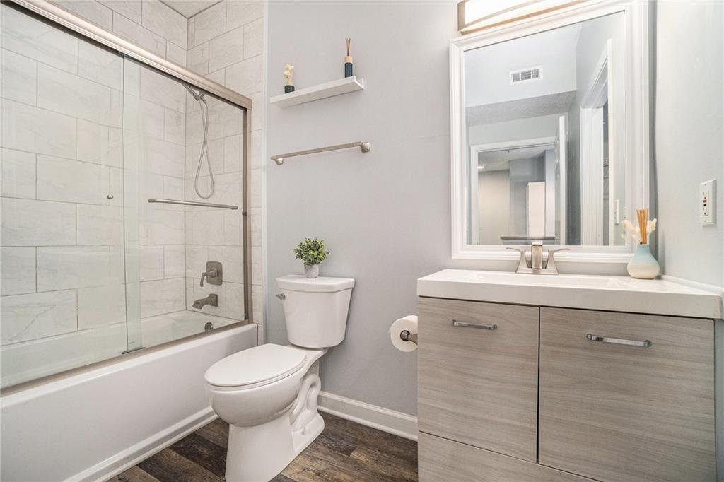 955 Juniper Street Northeast, Unit 3026 Atlanta, GA 30309 - Photo 18 of 32 a bathroom with a sink toilet and shower