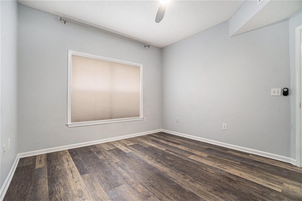 955 Juniper Street Northeast, Unit 3026 Atlanta, GA 30309 - Photo 20 of 32 a view of an empty room with wooden floor and a window