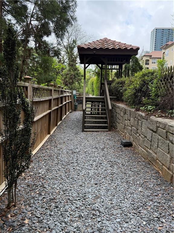 955 Juniper Street Northeast, Unit 3026 Atlanta, GA 30309 - Photo 26 of 32 a view of a chairs and table under an umbrella