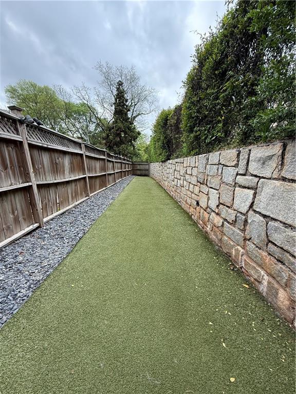 955 Juniper Street Northeast, Unit 3026 Atlanta, GA 30309 - Photo 29 of 32 a view of a backyard with wooden fence