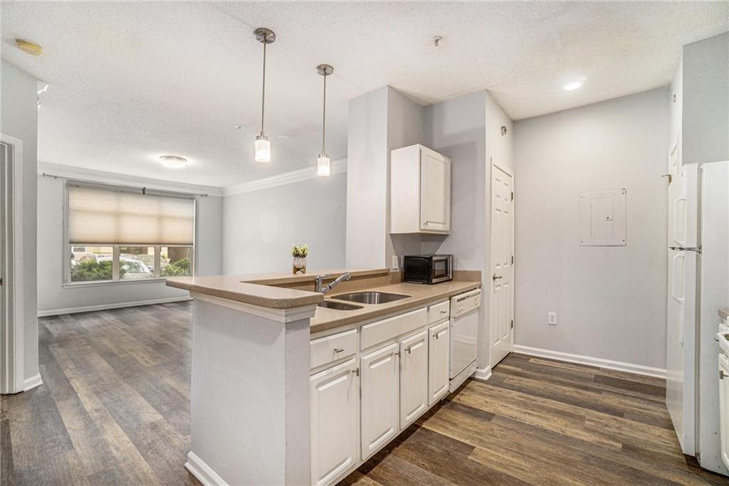 955 Juniper Street Northeast, Unit 3026 Atlanta, GA 30309 - Photo 6 of 32 a kitchen with a sink stove and wooden floor