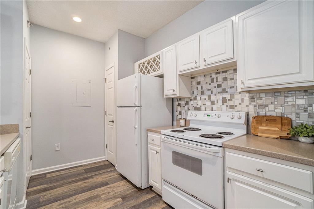 955 Juniper Street Northeast, Unit 3026 Atlanta, GA 30309 - Photo 8 of 32 a kitchen with white cabinets and white appliances
