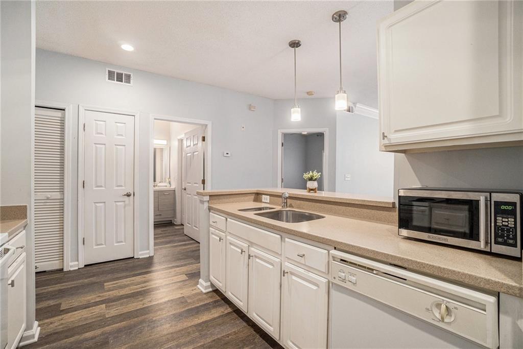 955 Juniper Street Northeast, Unit 3026 Atlanta, GA 30309 - Photo 10 of 32 a kitchen with a sink and a refrigerator