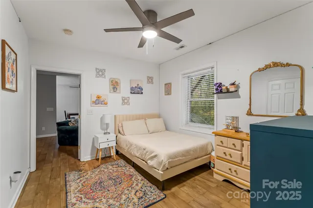 a bedroom with a bed and a dresser in it