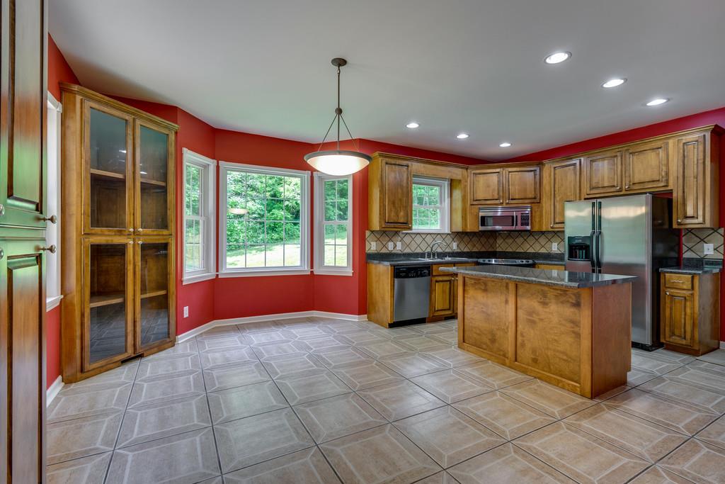 3853 Taylors Store Road Hampshire, TN 38461 - Photo 11 of 30 KITCHEN AND EATING AREA HAS TILE FLOOR AND BAY WINDOWS