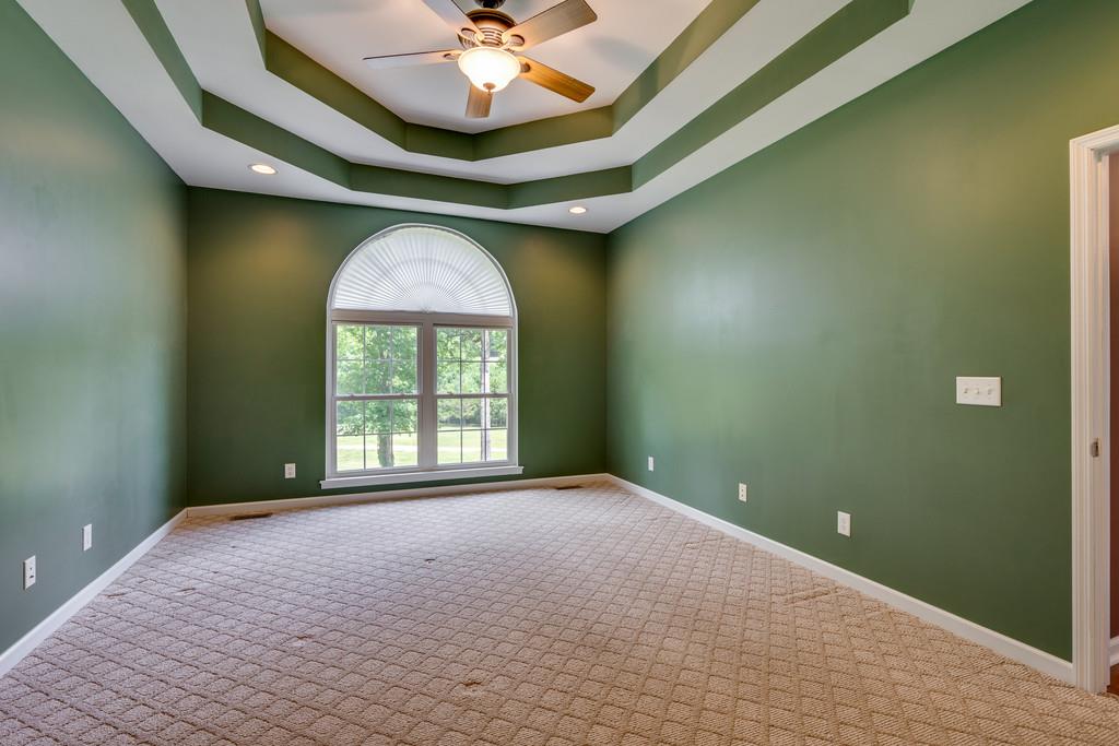 3853 Taylors Store Road Hampshire, TN 38461 - Photo 18 of 30 MASTER BEDROOM WITH CARPET ON THE FLOOR AND LARGE DOUBLE WINDOW WITH ARCHED WINDOW OVER SQUARE WINDOW