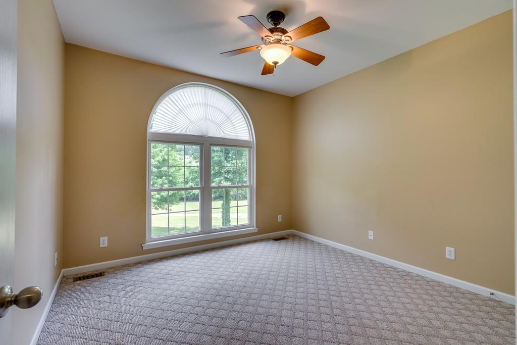 3853 Taylors Store Road Hampshire, TN 38461 - Photo 23 of 30 SECOND BEDROOM WITH ARCHED WINDOW OVER SQUARE WINDOW AND CARPET ON THE FLOOR