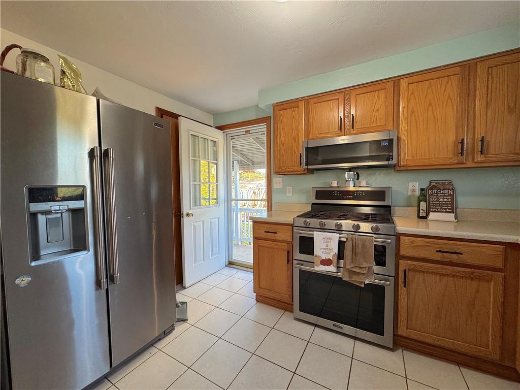 2030 Leo Street Irwin, PA 15642 - Photo 11 of 33 a kitchen with stainless steel appliances granite countertop a stove top oven a refrigerator and a sink