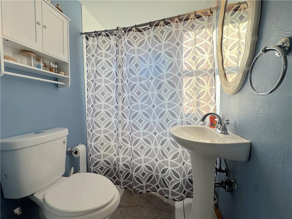 2030 Leo Street Irwin, PA 15642 - Photo 14 of 33 a bathroom with a sink a toilet and a mirror