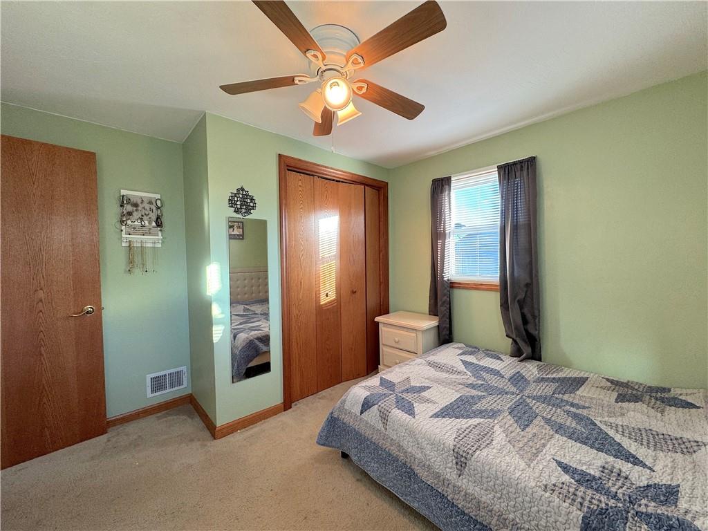 2030 Leo Street Irwin, PA 15642 - Photo 15 of 33 a bedroom with a bed and a chandelier