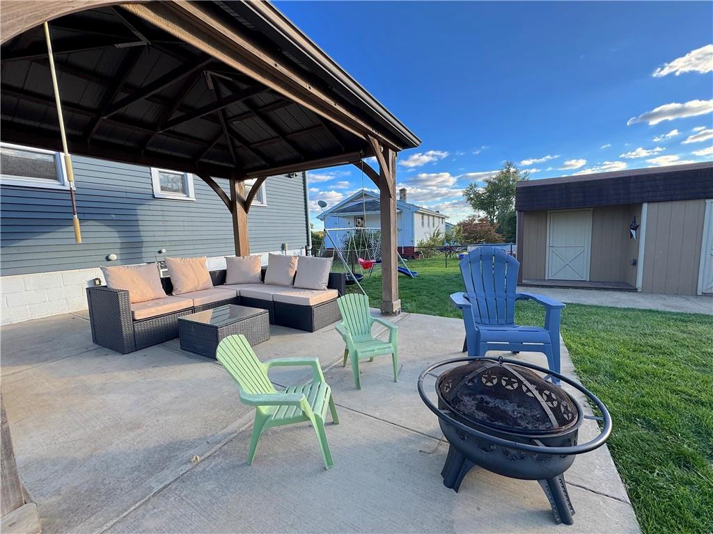 2030 Leo Street Irwin, PA 15642 - Photo 25 of 33 a view of a backyard with table and chairs under an umbrella with a small yard