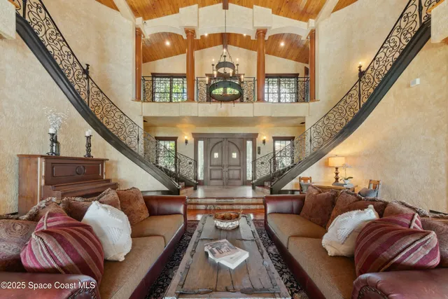 an aerial view of residential houses with outdoor space and trees