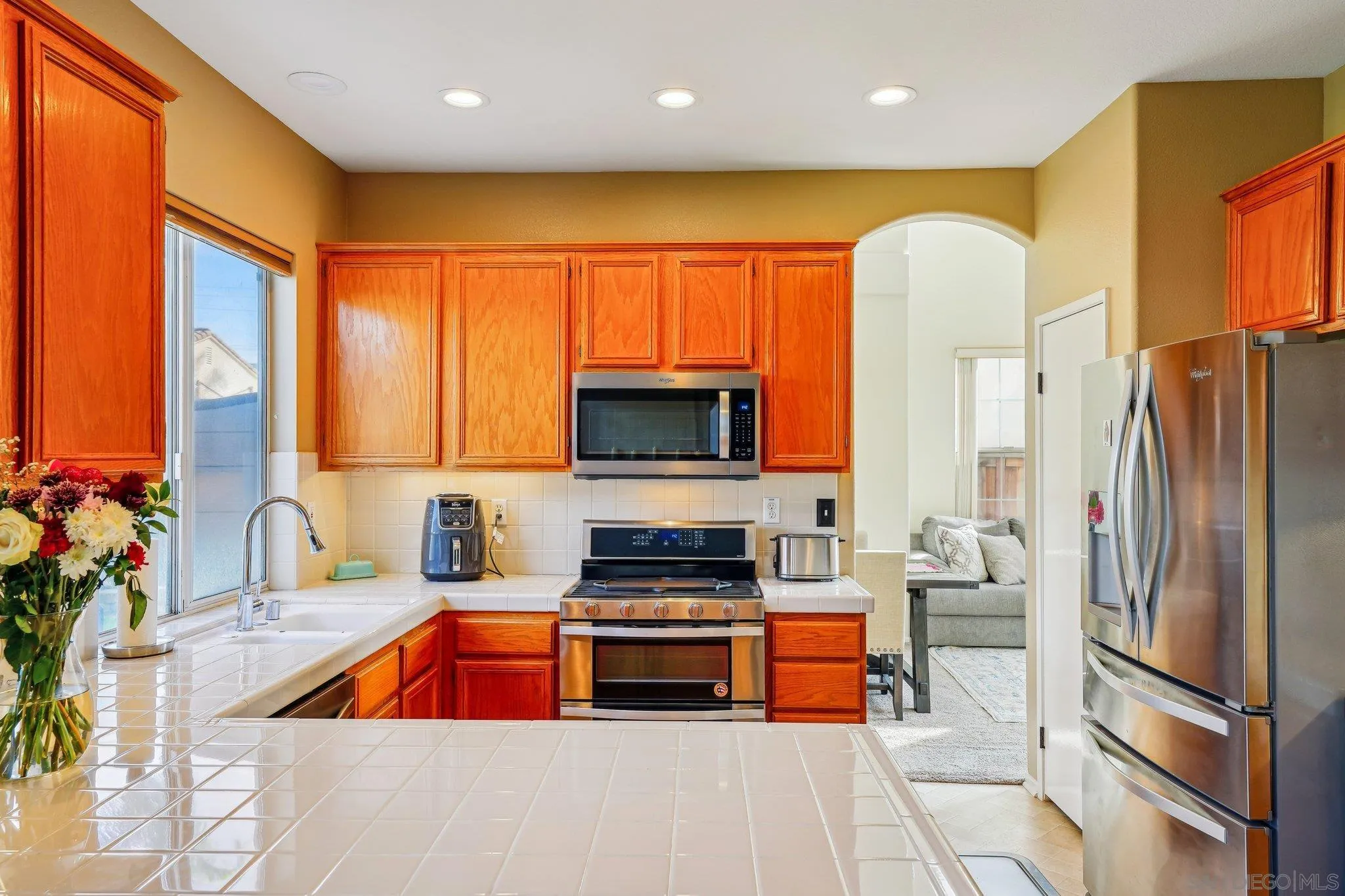 43166 Sereno Drive Temecula, CA 92592 - Photo 17 of 44 a kitchen with stainless steel appliances a refrigerator and a stove top oven