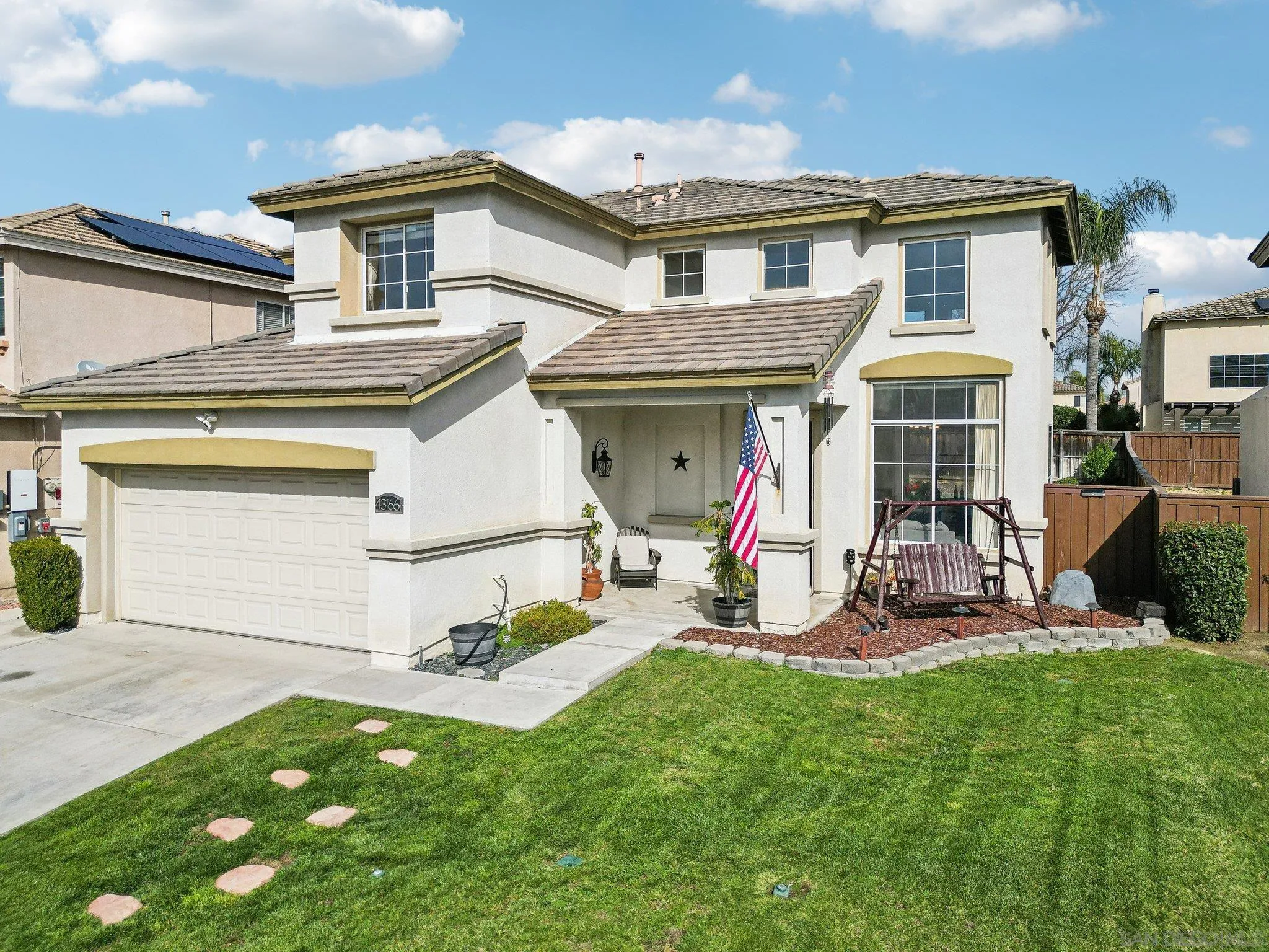 43166 Sereno Drive Temecula, CA 92592 - Photo 2 of 44 a front view of a house with a yard and a garage