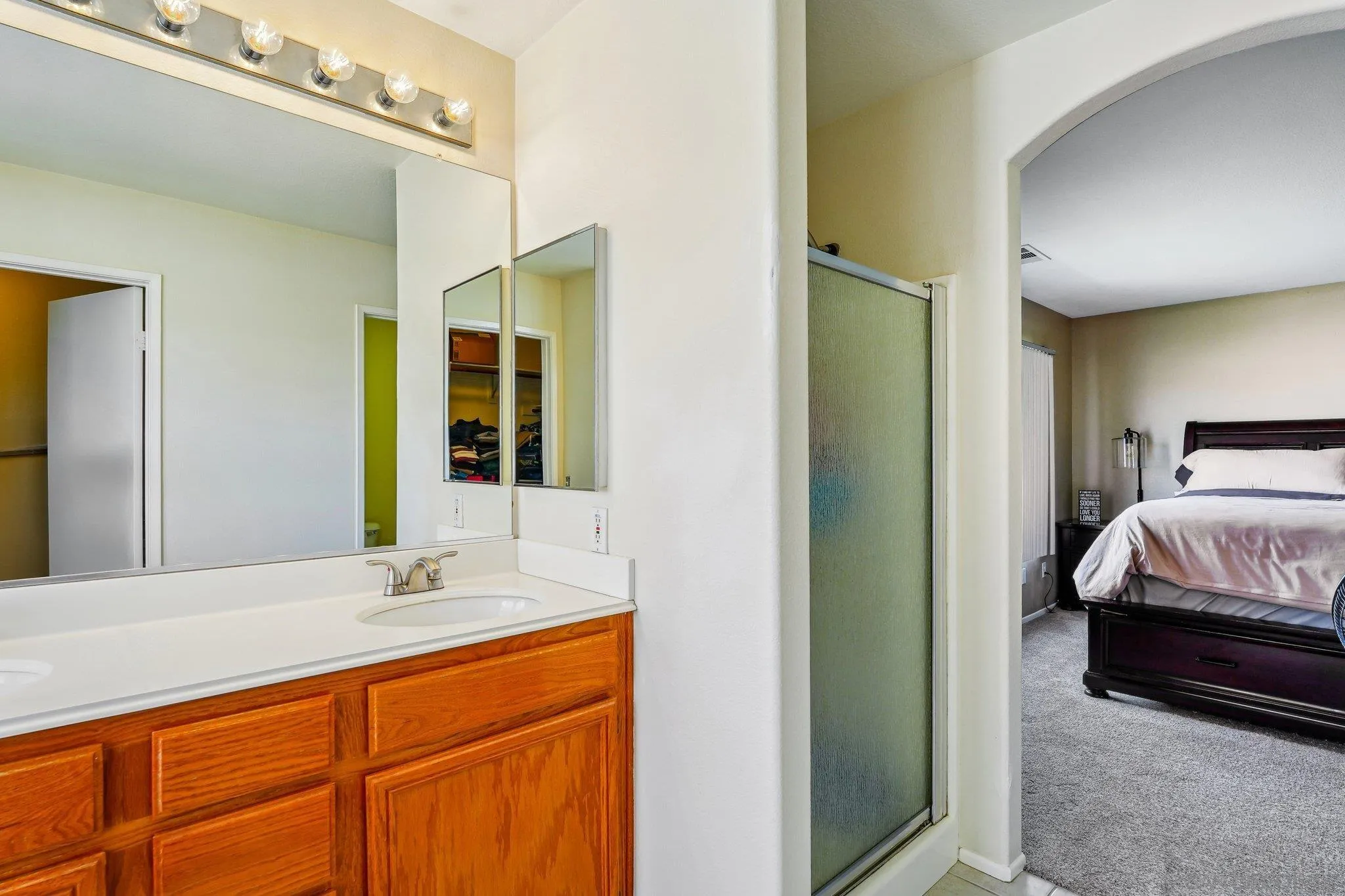 43166 Sereno Drive Temecula, CA 92592 - Photo 26 of 44 a bedroom with a sink and a mirror
