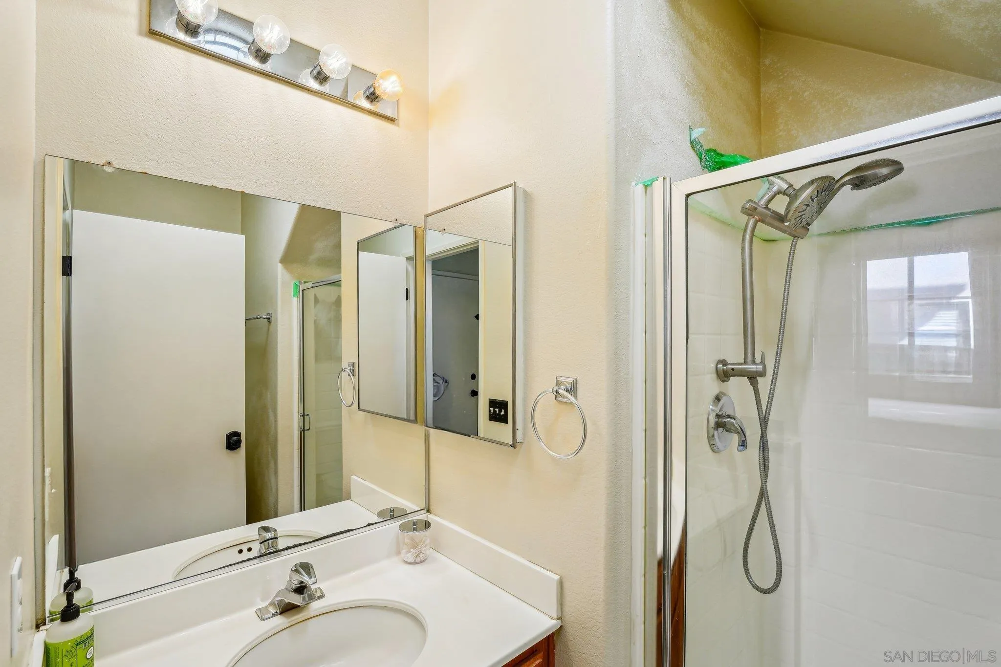 43166 Sereno Drive Temecula, CA 92592 - Photo 35 of 44 a bathroom with a shower sink and mirror