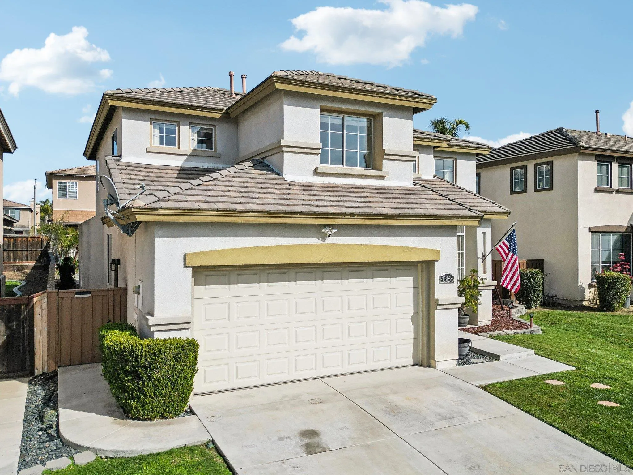 43166 Sereno Drive Temecula, CA 92592 - Photo 42 of 44 a front view of a house with a garden and garage