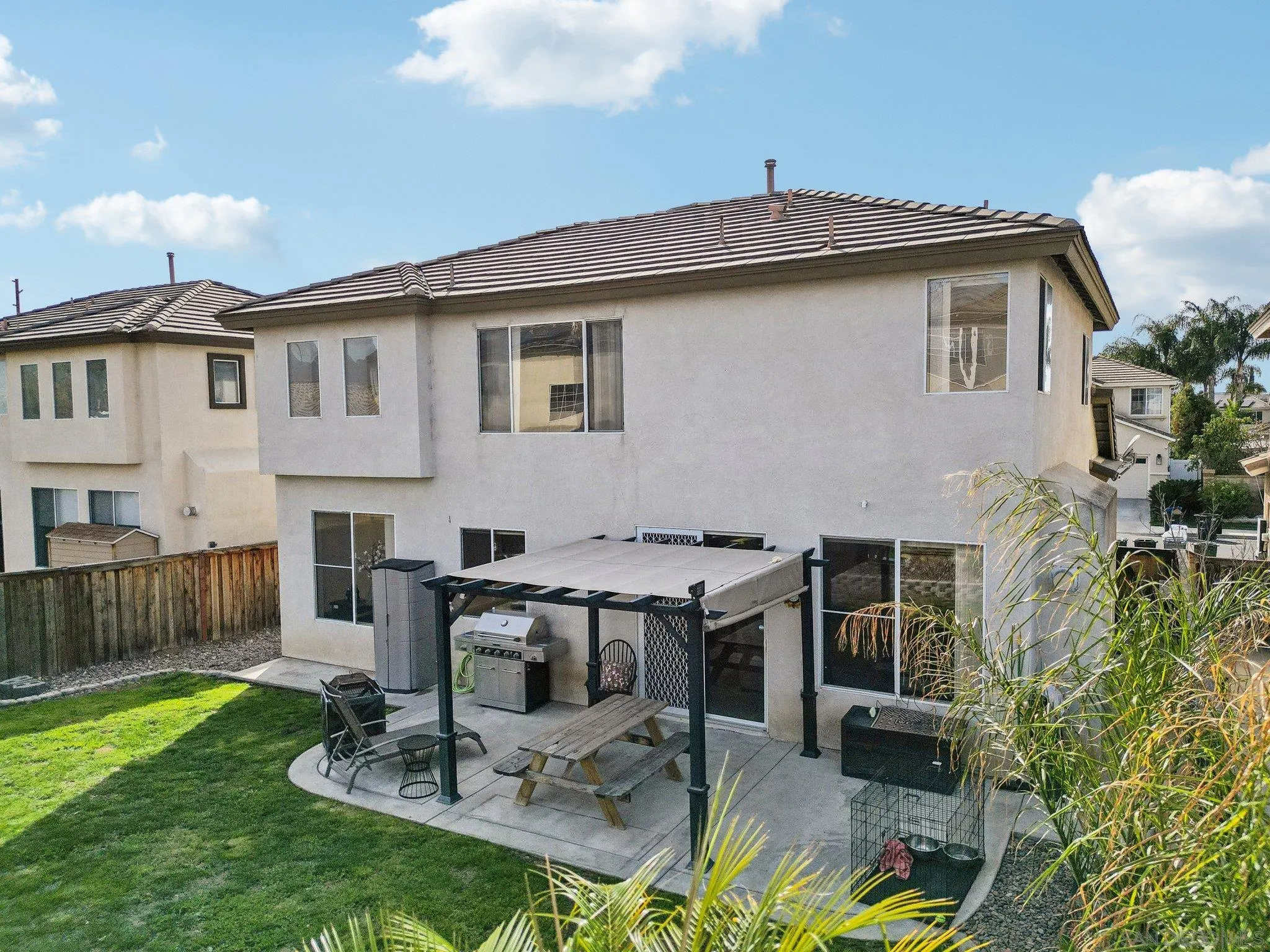43166 Sereno Drive Temecula, CA 92592 - Photo 9 of 44 a view of a patio with table and chairs with wooden fence