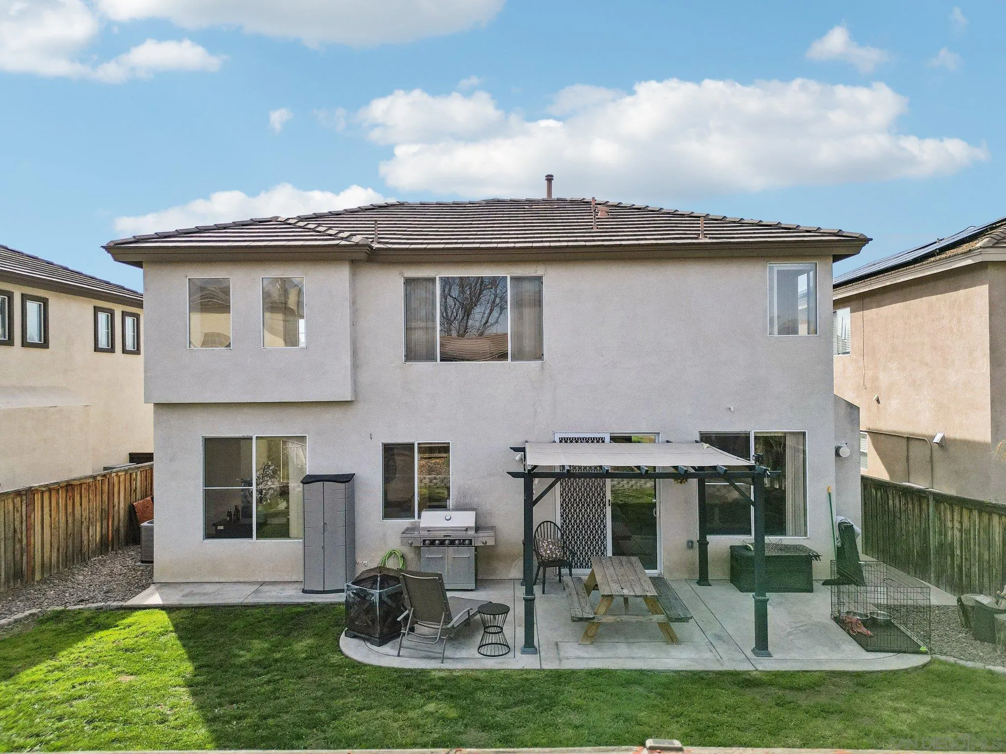 43166 Sereno Drive Temecula, CA 92592 - Photo 10 of 44 a front view of a house with a garden and plants