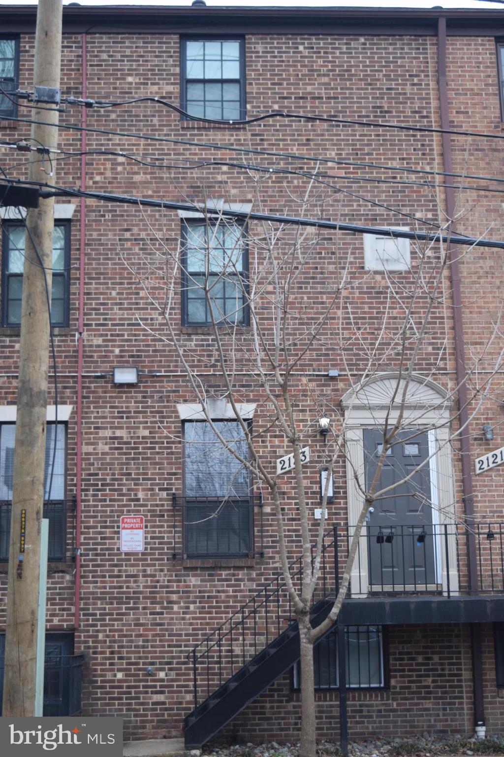 2123 Young Street Southeast, Unit 203 Washington, DC 20020 - Photo 1 of 10 a brick building with a glass door