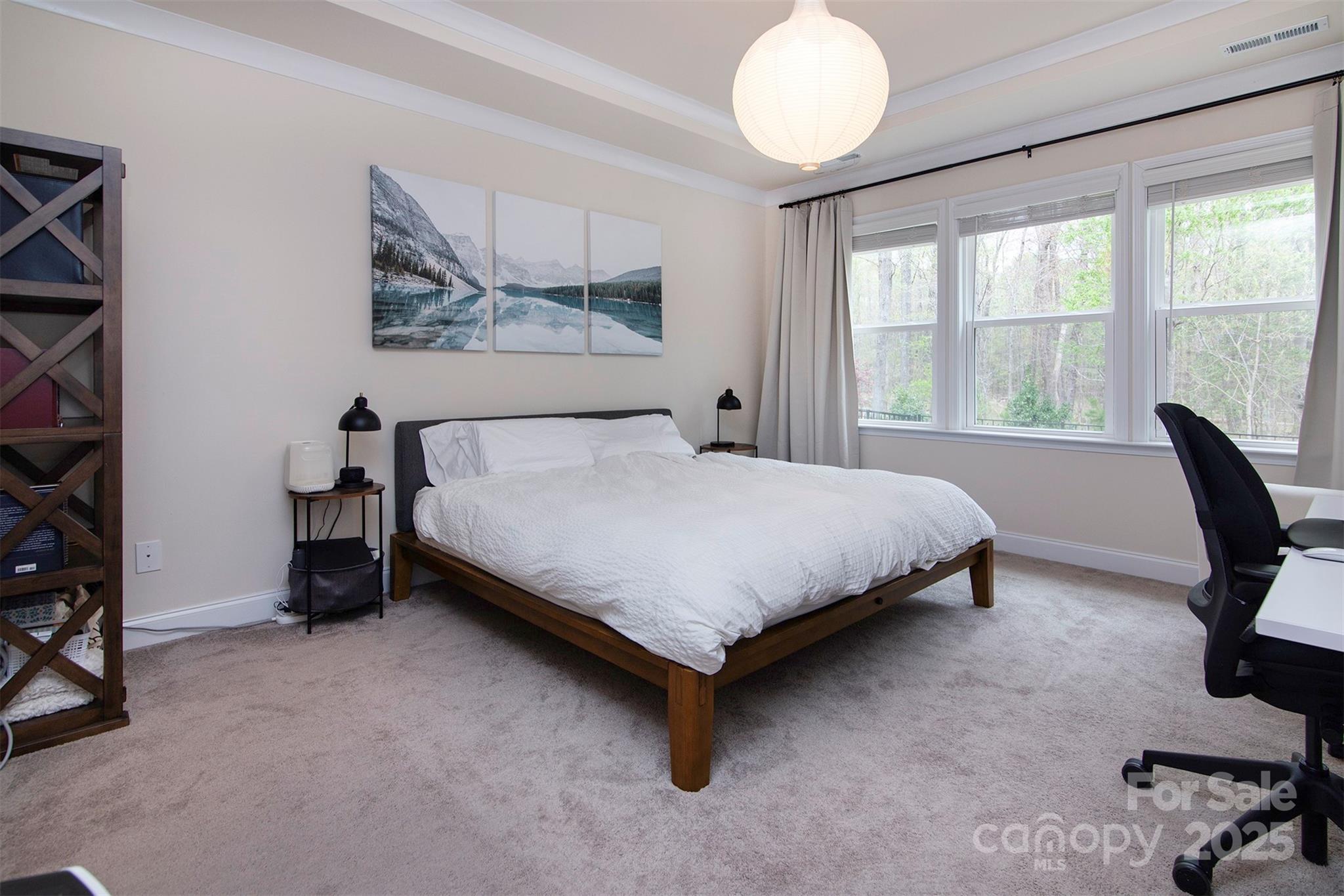 938 Moose Trail Matthews, NC 28104 - Photo 11 of 23 a bedroom with a bed and a chandelier