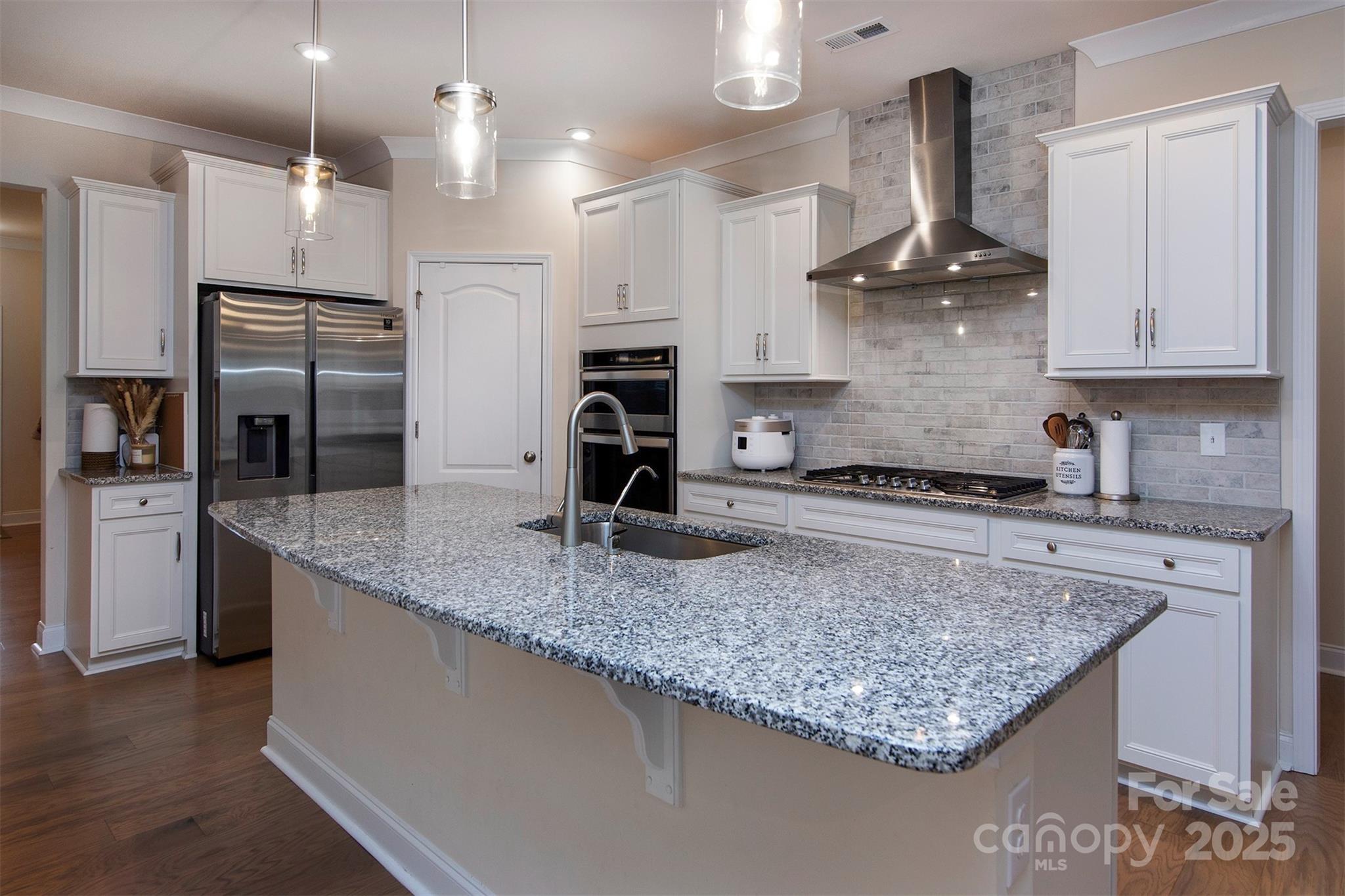 938 Moose Trail Matthews, NC 28104 - Photo 2 of 23 a kitchen with stainless steel appliances granite countertop a sink a stove and a refrigerator