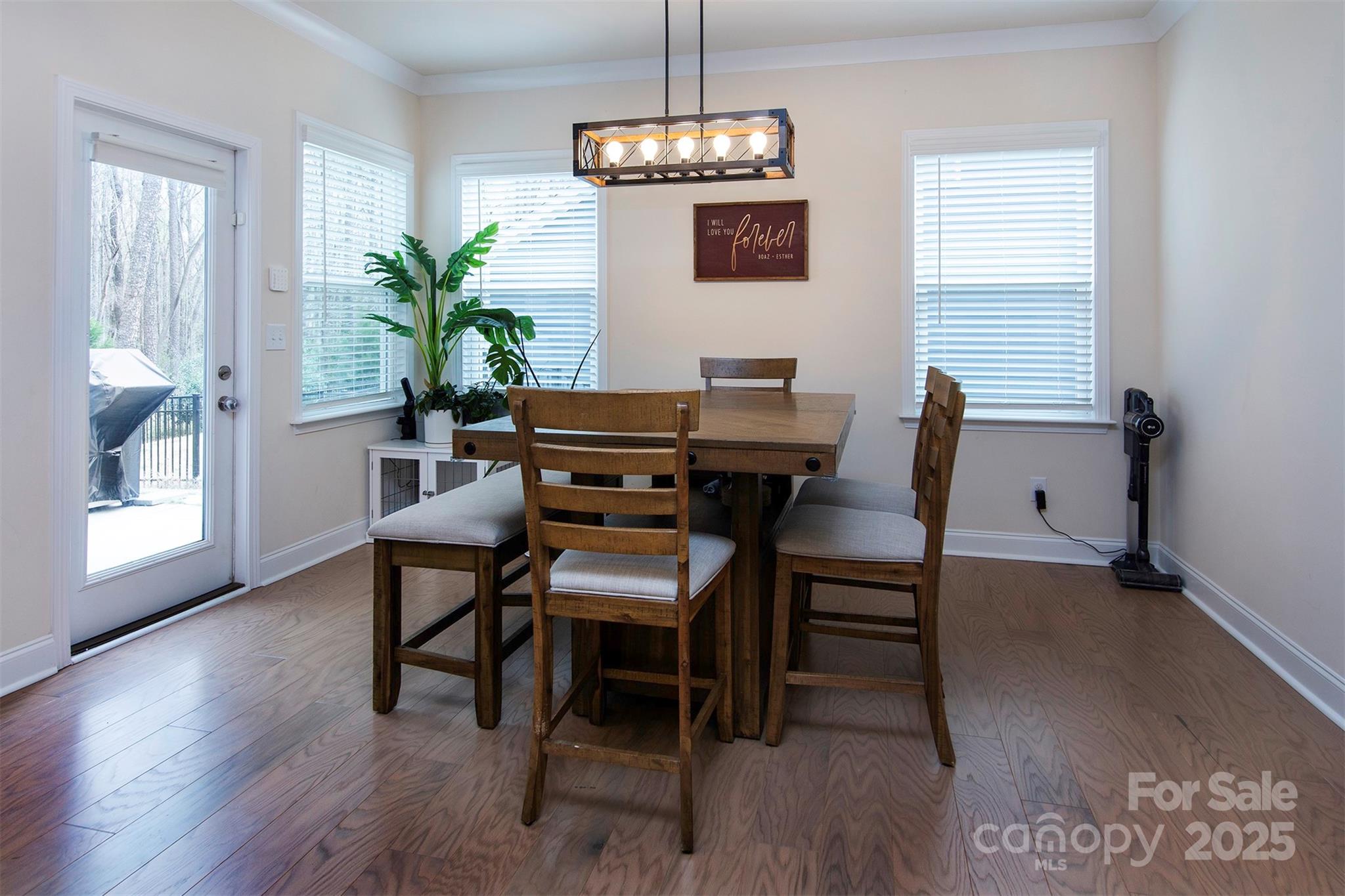 938 Moose Trail Matthews, NC 28104 - Photo 6 of 23 a dining room with furniture potted plants and wooden floor
