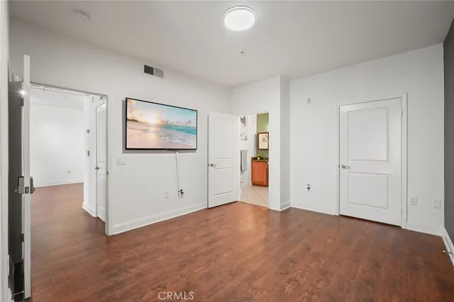 an empty room with windows and closet