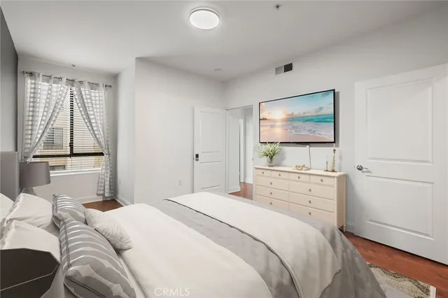 a bedroom with a bed and a flat screen tv