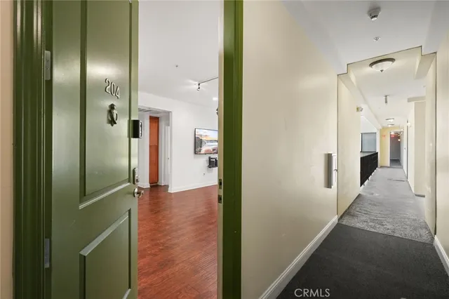 a view of a hallway with wooden floor