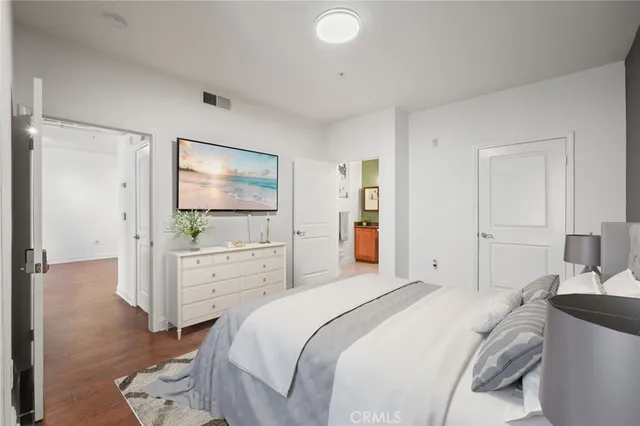 a bedroom with a bed and a flat screen tv