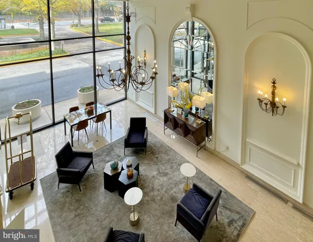 a living room with furniture and a chandelier