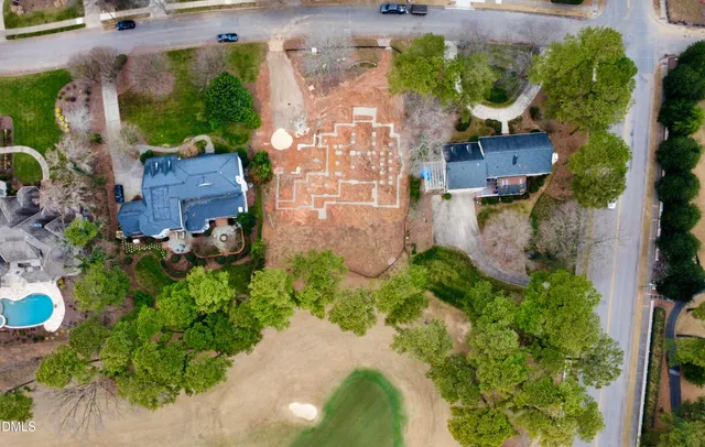 an aerial view of a house with a yard and garden