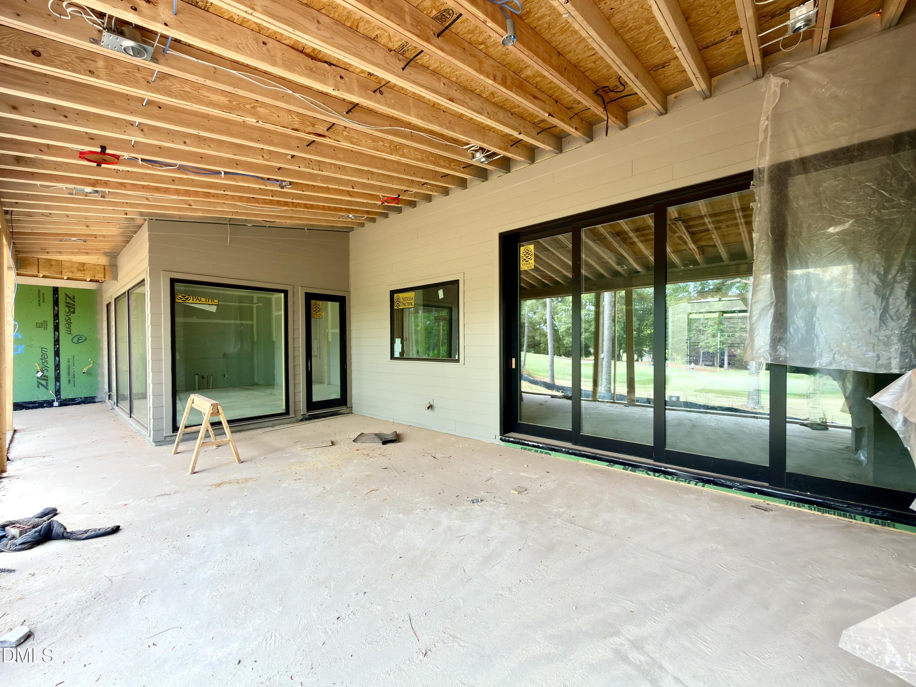 7136 North Ridge Drive Raleigh, NC 27615 - Photo 39 of 68 a view of a porch with a table and chairs and floor to ceiling window