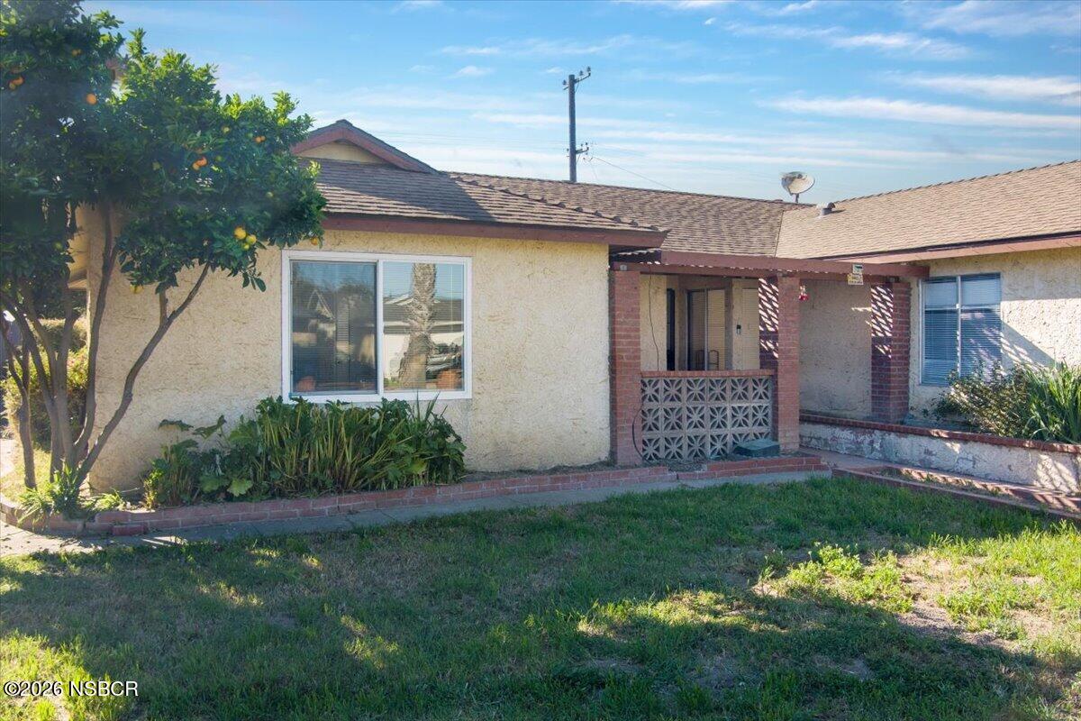 321 North Z Street Lompoc, CA 93436 - Photo 3 of 33 a front view of a house with a garden