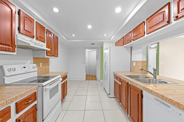 a kitchen with stainless steel appliances granite countertop a stove and a sink