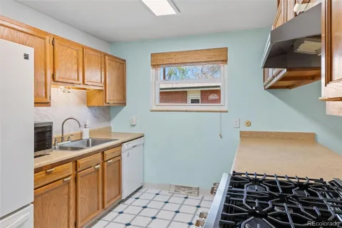 a kitchen with a sink and a stove top oven