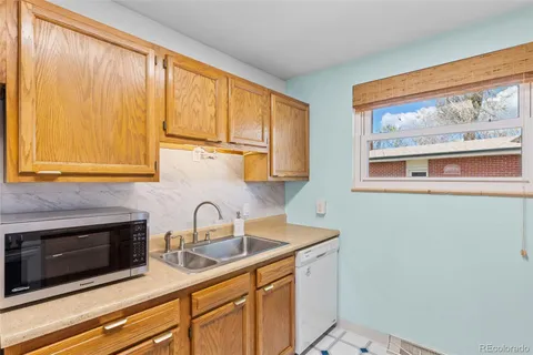 a kitchen with stainless steel appliances a sink a stove and a microwave