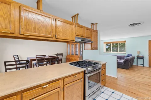 a kitchen with stainless steel appliances granite countertop a stove and a sink
