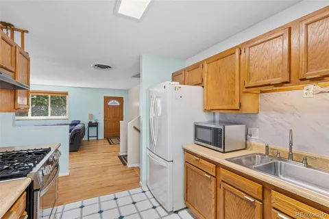a kitchen with stainless steel appliances a refrigerator sink and cabinets