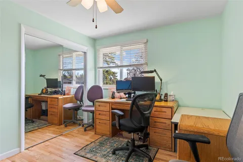 a view of a workspace with furniture and a window