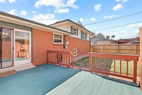 a view of a house with a wooden deck
